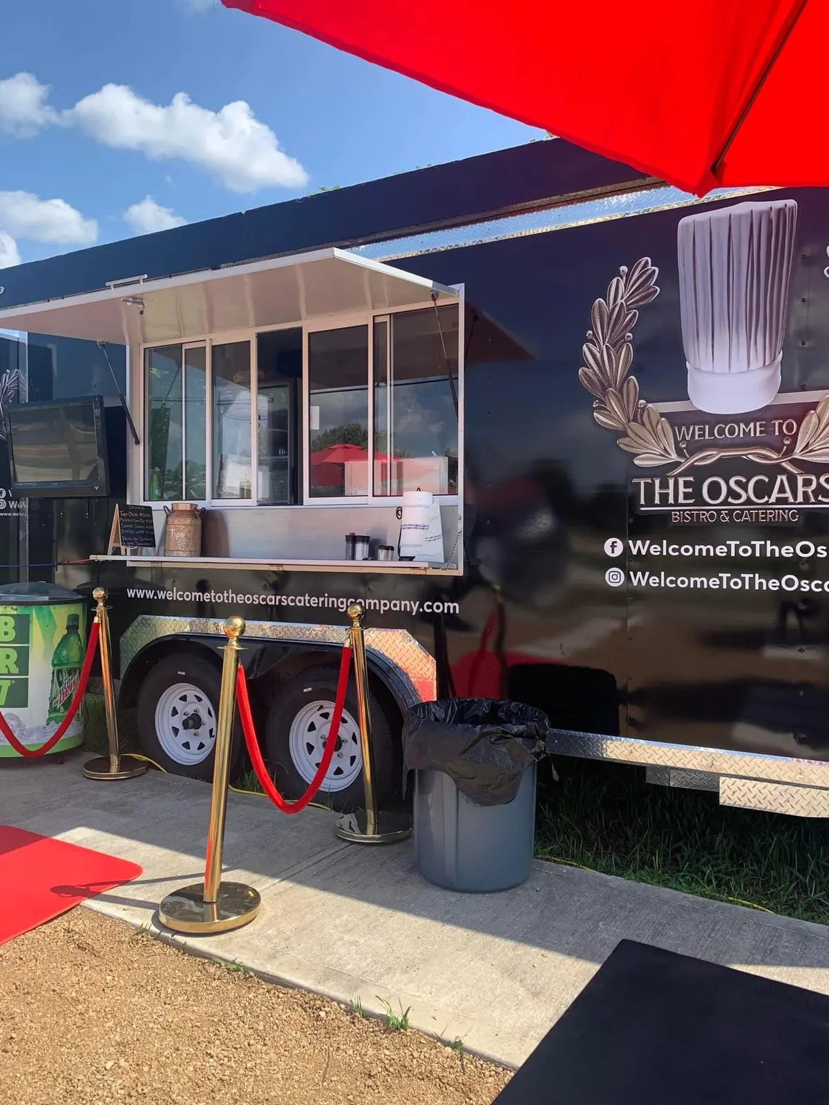 Oscar's original branded food truck with its serving window and crest